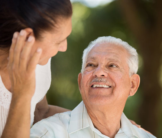 Elderly man smiling at daughter
