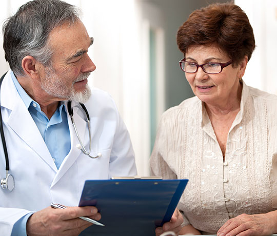 Physician consulting with older female patient