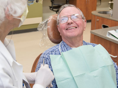 Seniors male receiving dental care