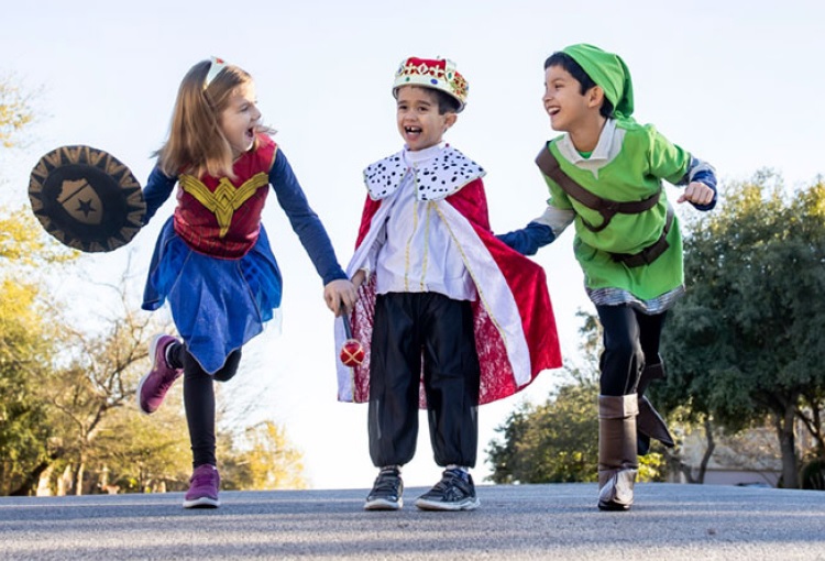 3 children playing in costumes