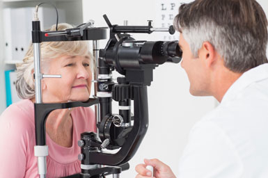 Eye doctor conducting eye exam on a patient