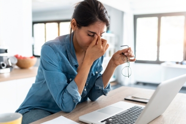 Women having a headache by the computer