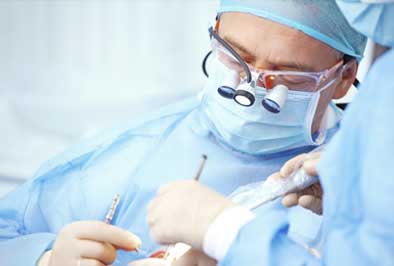 Oral surgeon performing surgery on a dental patient
